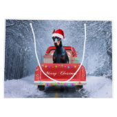 Doberman Dog in sneeuw, met Kerstmis Groot Cadeauzakje (Achterkant)