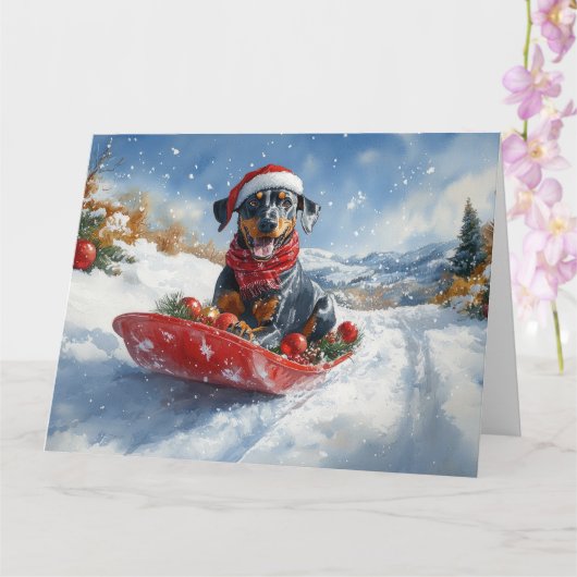 Doberman hond in slee laat het sneeuwen Kerstmis Kaart (Orchidee)
