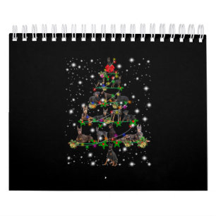 Doberman kerstboom bedekt door vlieglicht kalender
