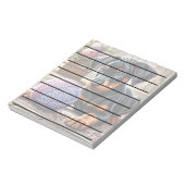 Doberman puppy met garenbal op een kleurrijk tapij notitieblok (Linkerzijde)