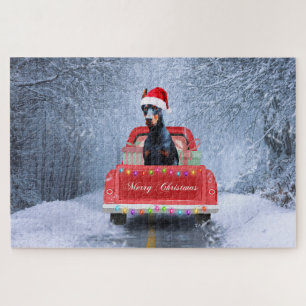 Dobermann-hond in de sneeuw zittend in de Kersttru Legpuzzel