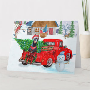Dobermann in kerstbezorgtruck sneeuw kaart