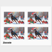 Dobermann loopt in de sneeuw met kerstmuts rechthoekige sticker (Vel)