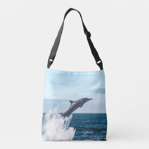 Dolfijn springt uit de oceaan crossbody tas
