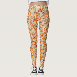 Draaiende oranje bladeren op beige achtergrond leggings