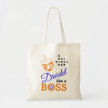 Dreidel als een Boss Hanukkah Tote Bag<br><div class="desc">Stijlvol DREIDEL ALS EEN BOSS Hanukkah-Canvas tas ontworpen met een oranje droomvormer en blauwe, oranje en zwarte typografie. In de rechterbovenhoek kunt u de namen van de vier driezijdige zijden lezen in een woordpuzzelformaat (HEI kan zo nodig worden gewijzigd in HEY of HAY). In de O van BOSS zit een...</div>