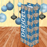 Dreidel Rustic Oak Fun Blauw en Wit Chanoeka Wijn Cadeautas<br><div class="desc">Perfect voor het schenken van een fles wijn op een van de nachten van Chanoeka, deze gepersonaliseerde Chanoeka-wijncadeautas maakt een gedurfde uitspraak. Versierd met afbeeldingen rustieke dreidels in een gesimuleerde eikenhouten afbeelding, zet de donkermedium blauwe achtergrond van deze aangepaste Hanukkah hoge geschenktas het podium voor de jumbo typografie DREIDEL aan...</div>