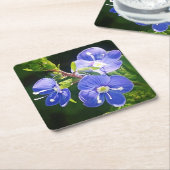 Drie blauwe bloemen kartonnen onderzetters (Schuin)