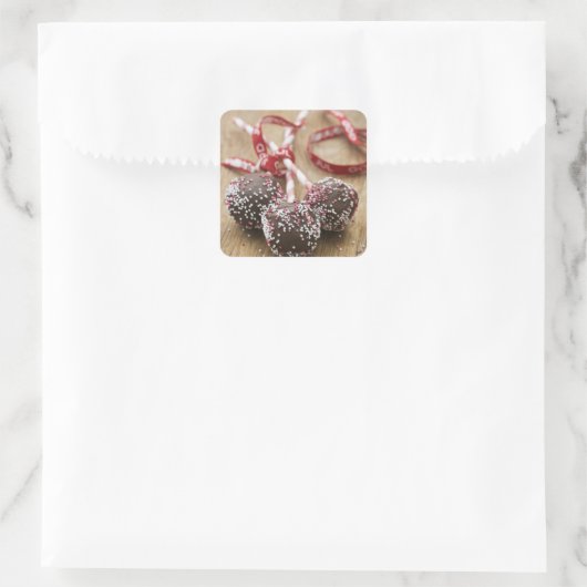 Drie chocoladelollipops vierkante sticker (Tas)