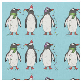 Drie feestelijke kerstpinguïns op lichtblauw stof