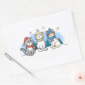 Drie katten die kerstmanolen zingen in de sneeuwce ovale sticker (Envelop)