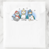 Drie katten die kerstmanolen zingen in de sneeuwce ovale sticker (Tas)