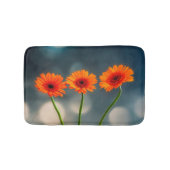 Drie Oranje Gerberas in een Row Bath mat (Voorkant)
