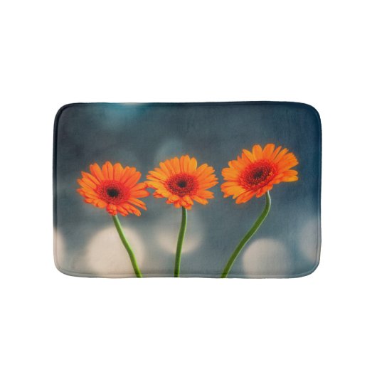 Drie Oranje Gerberas in een Row Bath mat (Voorkant)