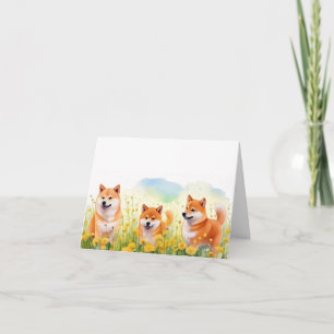 Drie schattige Shiba Inus en paardenbloemen wenska Kaart