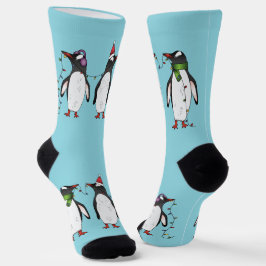 Drie vrolijke kerstpinguïns op lichtblauw sokken