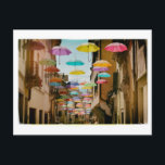 drijvende paraplu's briefkaart<br><div class="desc">Grappige paraplu's die boven een straat zweven.</div>