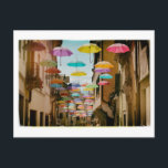 drijvende paraplu's briefkaart<br><div class="desc">Grappige paraplu's die boven een straat zweven.</div>