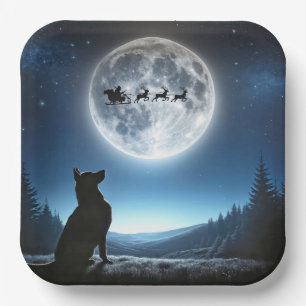 Duitse herder kijkt naar kerstman en rendier papieren bordje