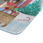 Duitse herderhond in het sneeuwkersthondenhuis snijplank (Hoek)