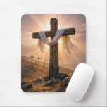 Easter Crosses On a Hill Muismat<br><div class="desc">A central wooden cross,  covered with a white cloth and illuminated by the warm glow of the setting sun,  stands out against two additional crosses on a rocky hillside in the background</div>