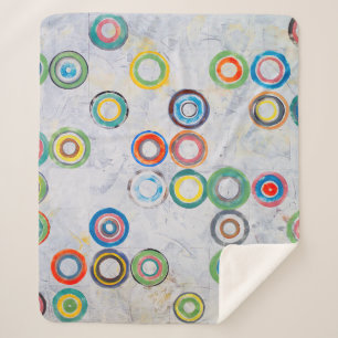 Een abstract schilderij; multicolored cirkels op e sherpa deken