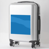 Een blauwe achtergrond met een sticker (Koffer)