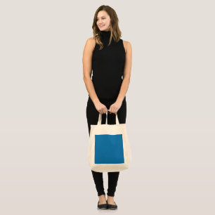 Een blauwe achtergrond met een zwart-witte klok tote bag