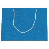 Een blauwe cadeautas met witte handvatten (Voorkant)
