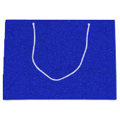 Een blauwe glinsterende cadeautas met witte handva (Voorkant)