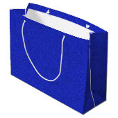 Een blauwe glinsterende cadeautas met witte handva (Achterkant Gekanteld)