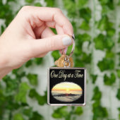 EEN DAG IN EEN TIJD ZONSOPGANG FOTO SLEUTELHANGER (Hand)