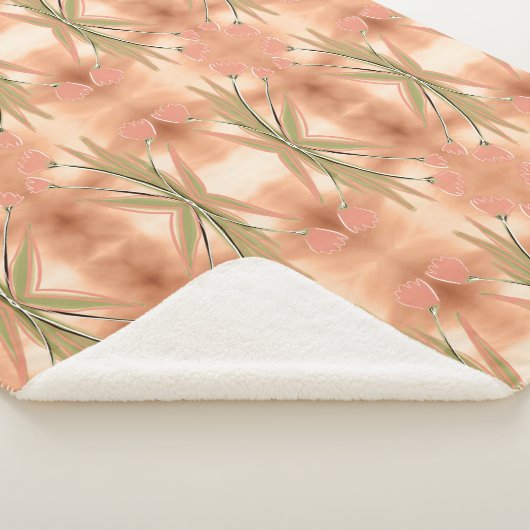 Een deken met een roze en koraal tulpenprint (3/4)