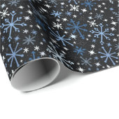 Een griezelige mest van blauwe sneeuwvlokken op zw cadeaupapier (Rol Hoek)