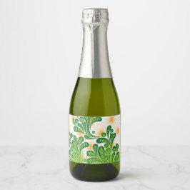 Een groen en goud artistiek patroon met een boom sparkling wijnetiket