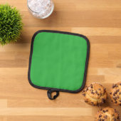 Een groene achtergrond met een witte rand pannenlap (Top down)