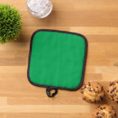 Een groene achtergrond met een witte rand pannenlap (Top down)