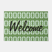 Een groene deurmat met een  dessin