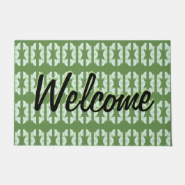 Een groene deurmat met een dessin