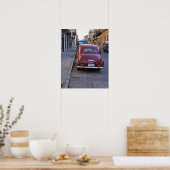 Een klassieke rode Peugeot-auto geparkeerd op stra Poster (Keuken)