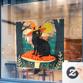 Een klein zwart heksachtig katje dat op een padde Raamsticker