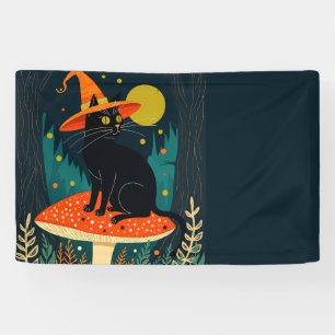 Een klein zwart heksachtig katje zittend op een pa spandoek