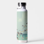 Een kudde vliegende meeuwen boven de oceaan. waterfles (Rechts)