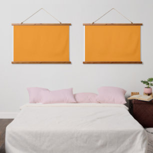 Een levendig oranje plein omgeven door een witte r hangend wandkleed