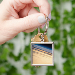 Een orbitale zonsondergang voor de kust van Baja C Sleutelhanger