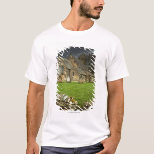 Een oude kerk onder een donkere hemel t-shirt