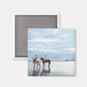 Een paar rijpaarden op het strand van Parkiri in N Magneet (Voorkant / Achterkant)