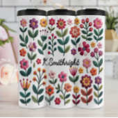 Een patroon van kleurrijke bloemen thermosbeker