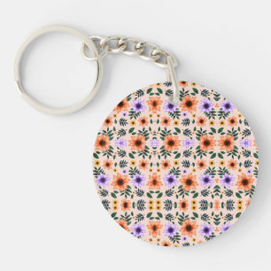 Een ronde sleutelhanger met een kleurrijk bloemmot