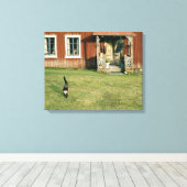 Een rood huis met een kat op het gazon. canvas afdruk (Insitu (Houten vloer))